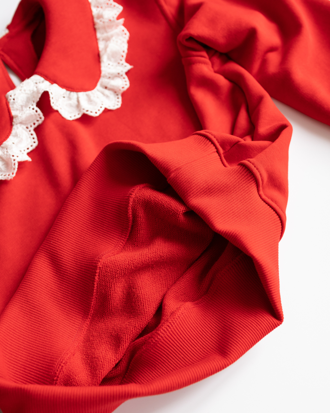 Soft interior texture of red cotton knit sweatshirt