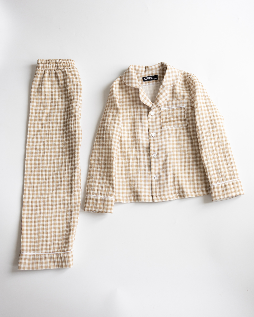 Beige cotton muslin pajama set for girls with checkered print – full view flat lay