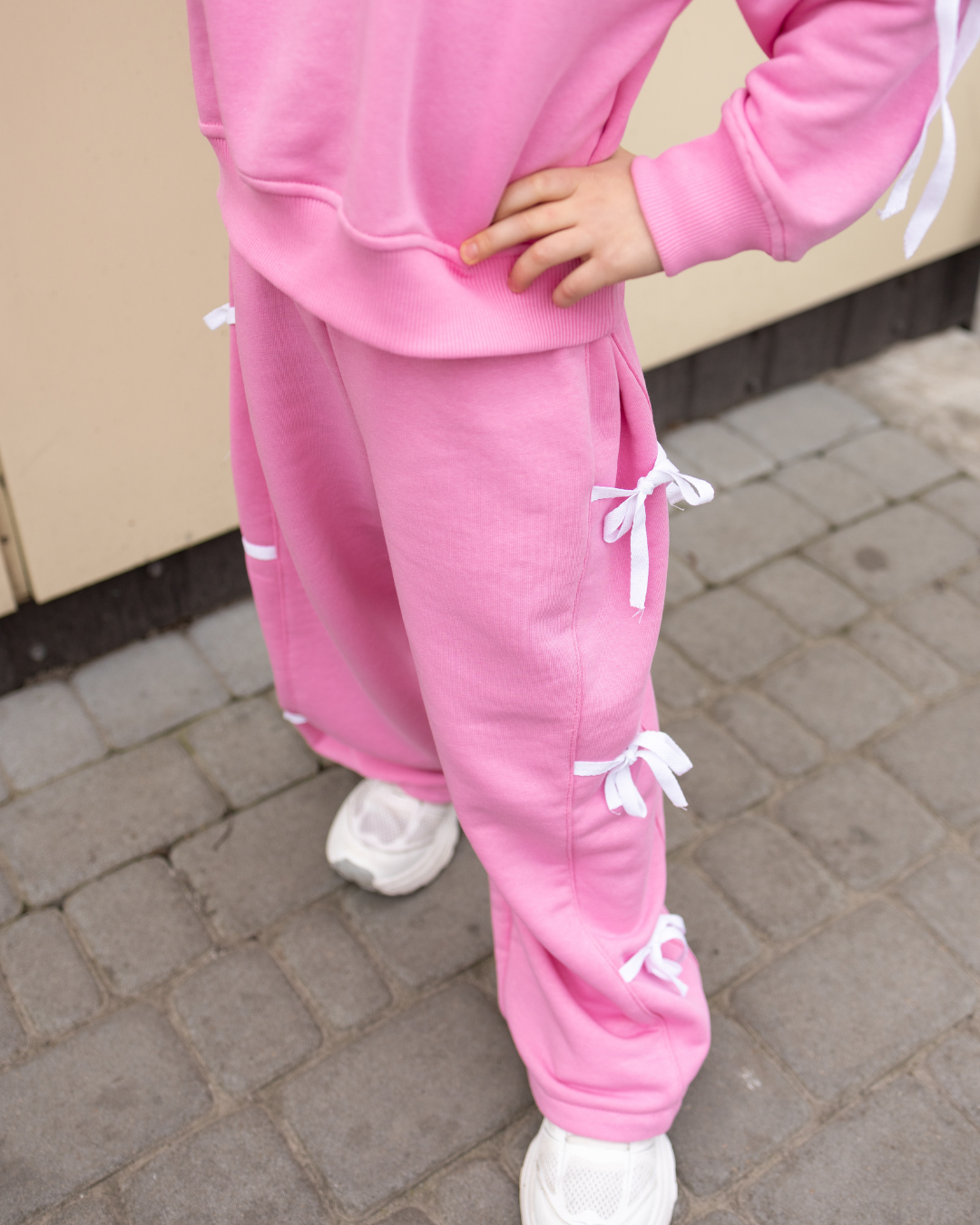Pink palazzo pants for girls with cute white bows by Alwair Kids outdoor view

