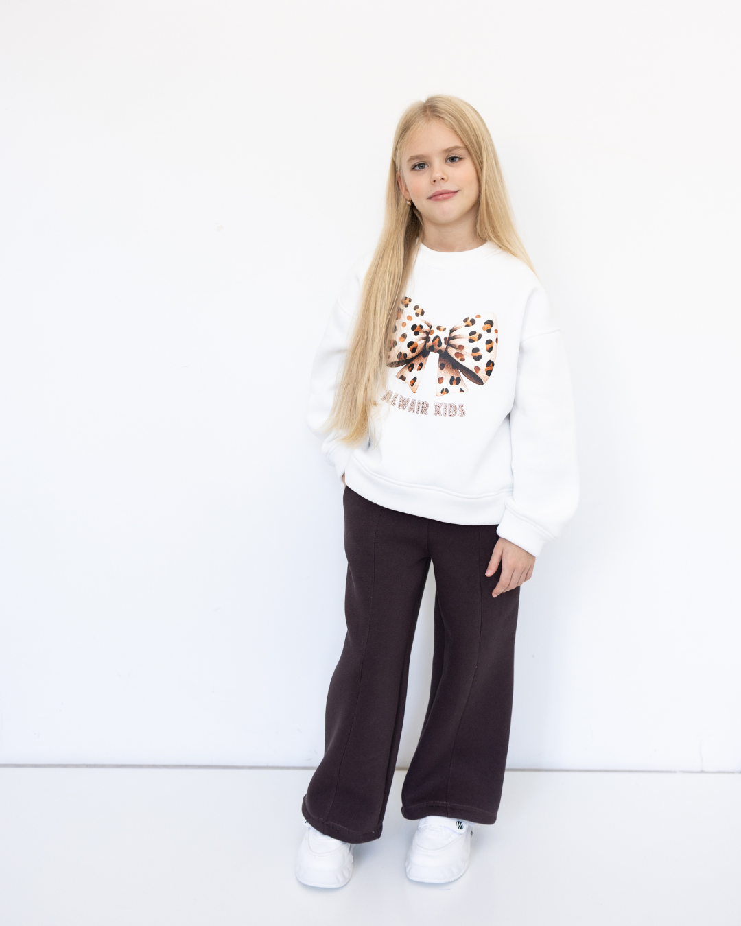 Girl wearing brown wide-leg knit palazzo pants by Alwair Kids front view