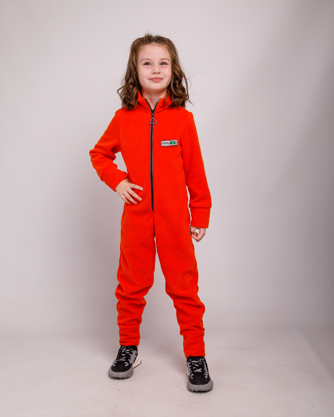Girl wearing orange fleece jumpsuit by Alwair Kids – front view