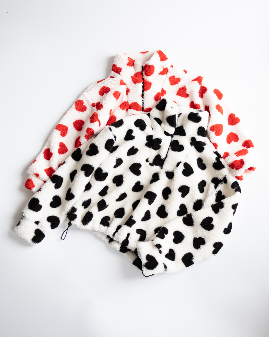 Two fleece pullovers with heart print – red and black by Alwair Kids