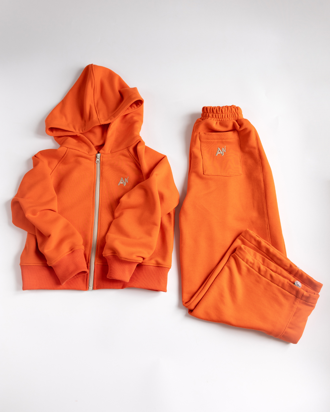 Orange kids tracksuit set with zip hoodie and drawstring pants by Alwair Kids