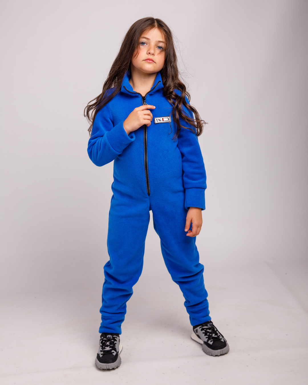 Girl wearing navy fleece jumpsuit by Alwair Kids – front view