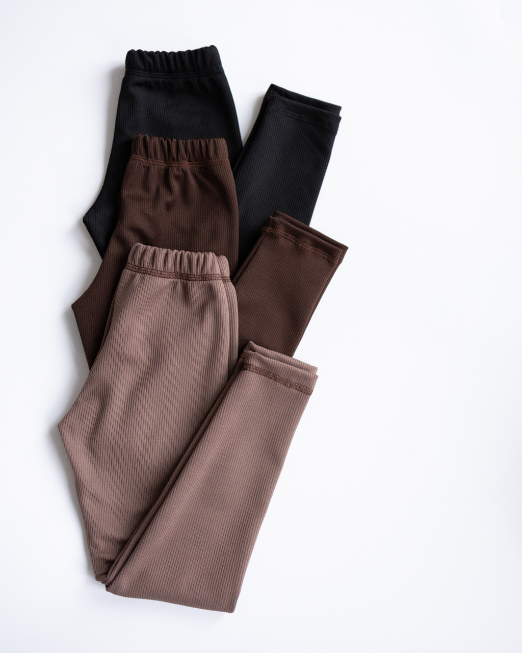 Top view of ribbed leggings in black brown and beige layered together - Alwair Kids