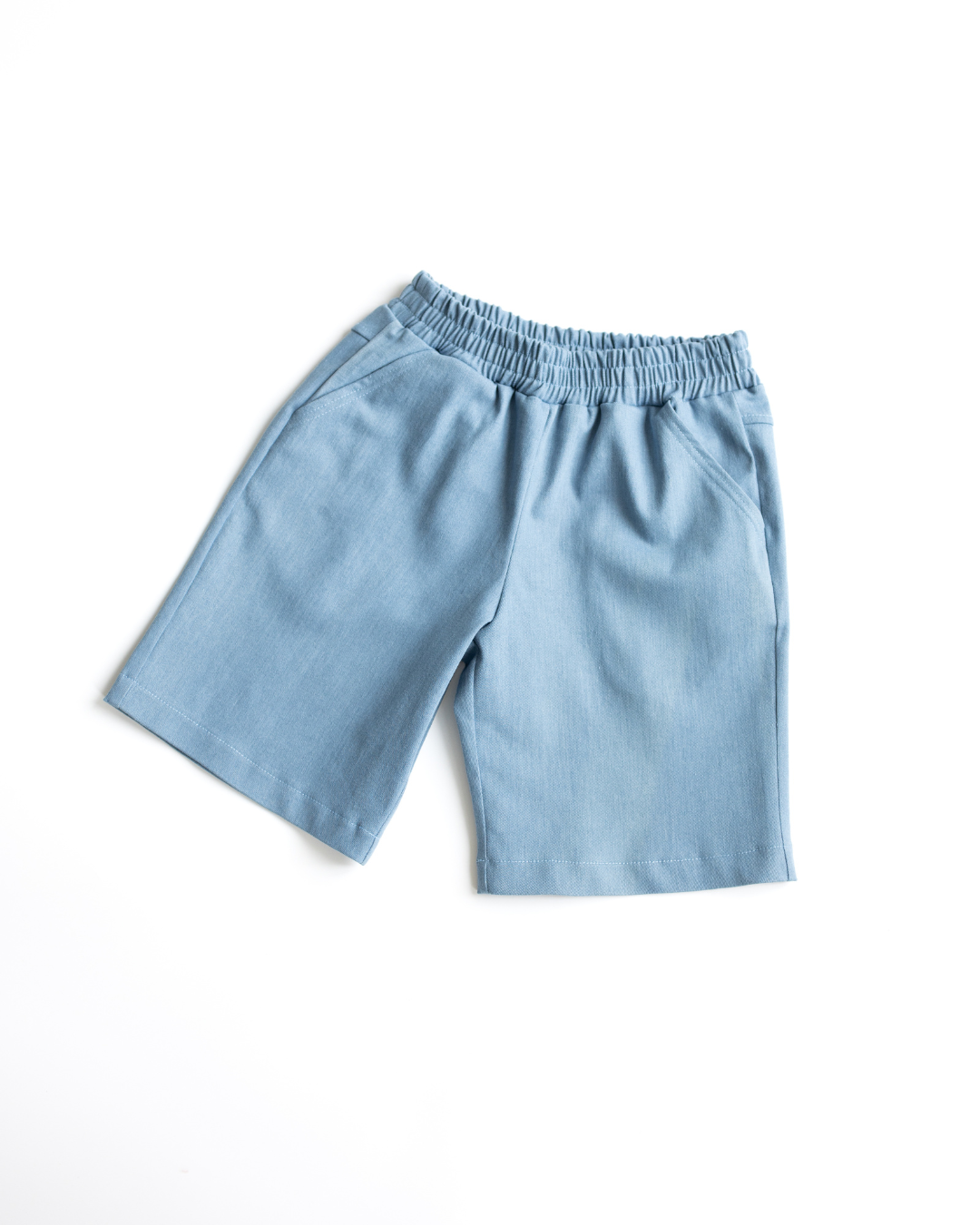 Main flat lay of kids' light blue denim shorts with elastic waistband and pockets