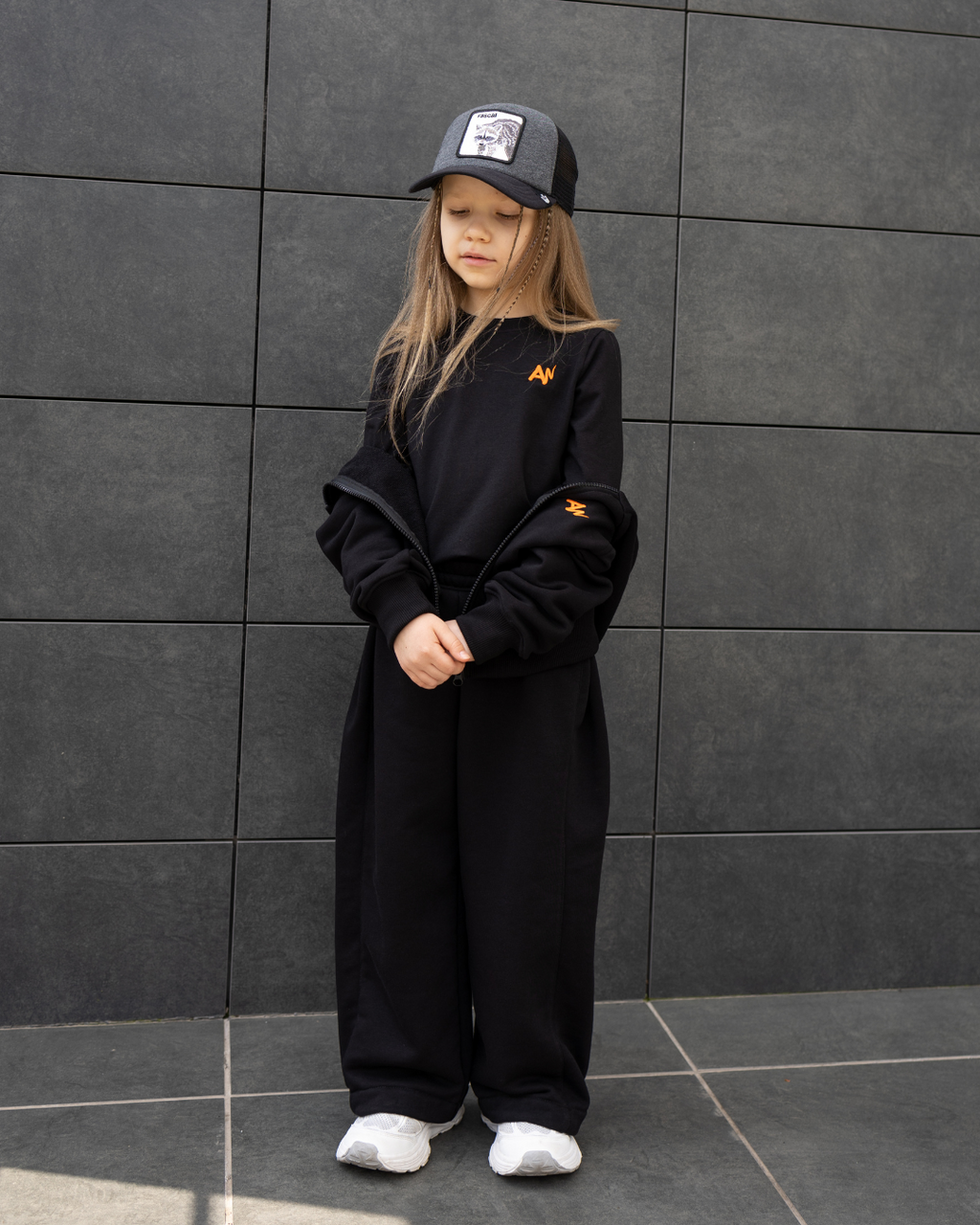 Child in full Alwair Kids tracksuit set with hoodie unzipped to show inner T-shirt