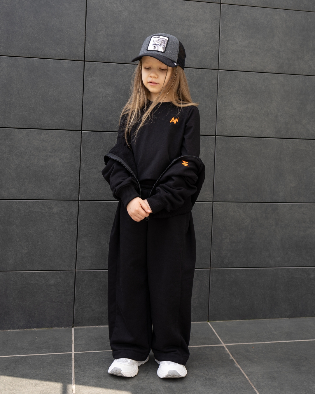 Child in full Alwair Kids tracksuit set with hoodie unzipped to show inner T-shirt