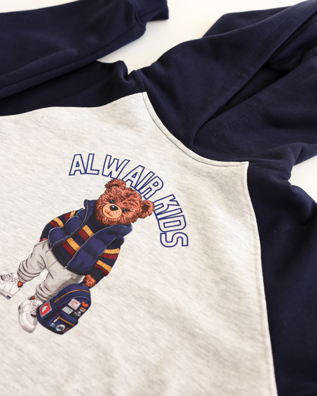 Close-up of teddy bear print on navy and grey hoodie for boys by Alwair Kids