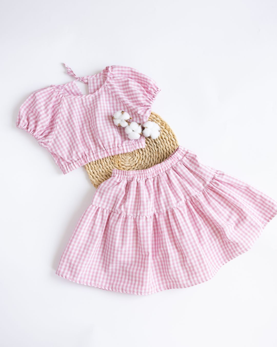 Flat lay of Blossom pink gingham cotton set with top and skort by Alwair Kids
