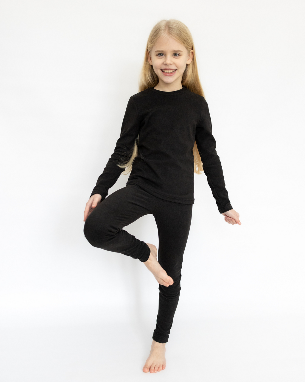 Child wearing black thermal underwear set Alwair Kids front view