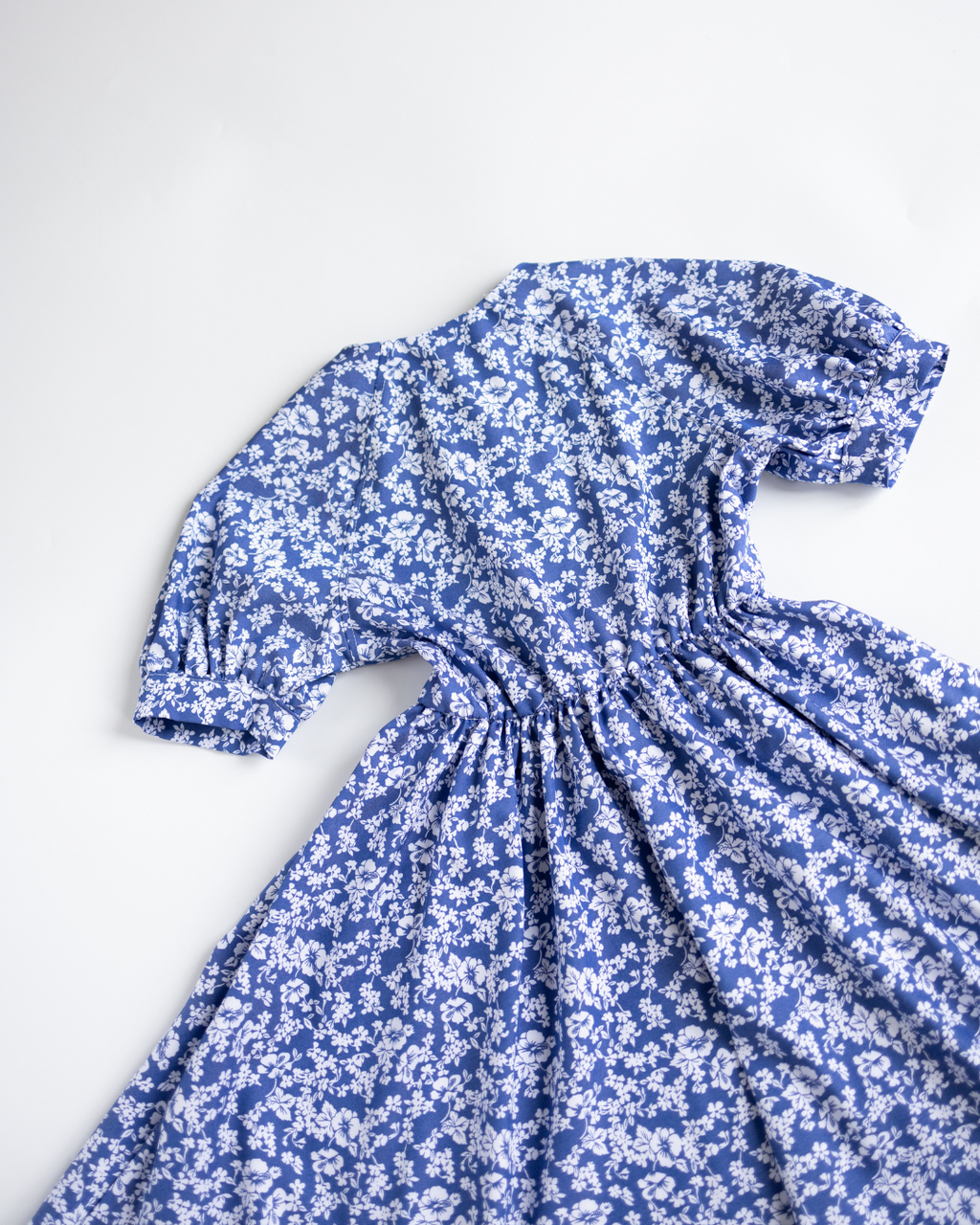 Back view of Alwair Kids girls tencel summer dress in blue and white floral print