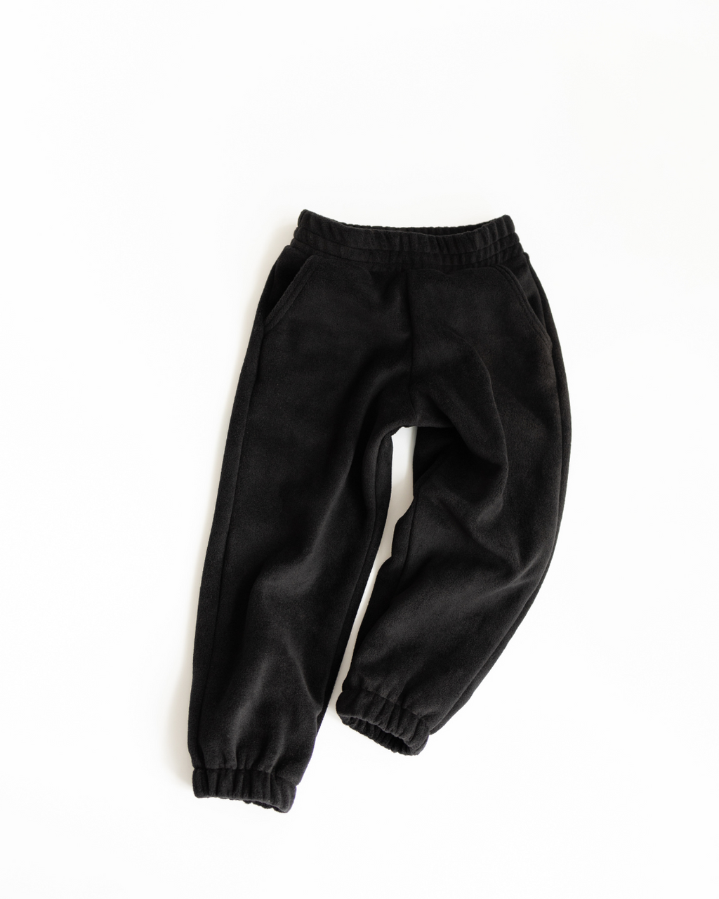 Black fleece jogger pants for children by Alwair Kids top view