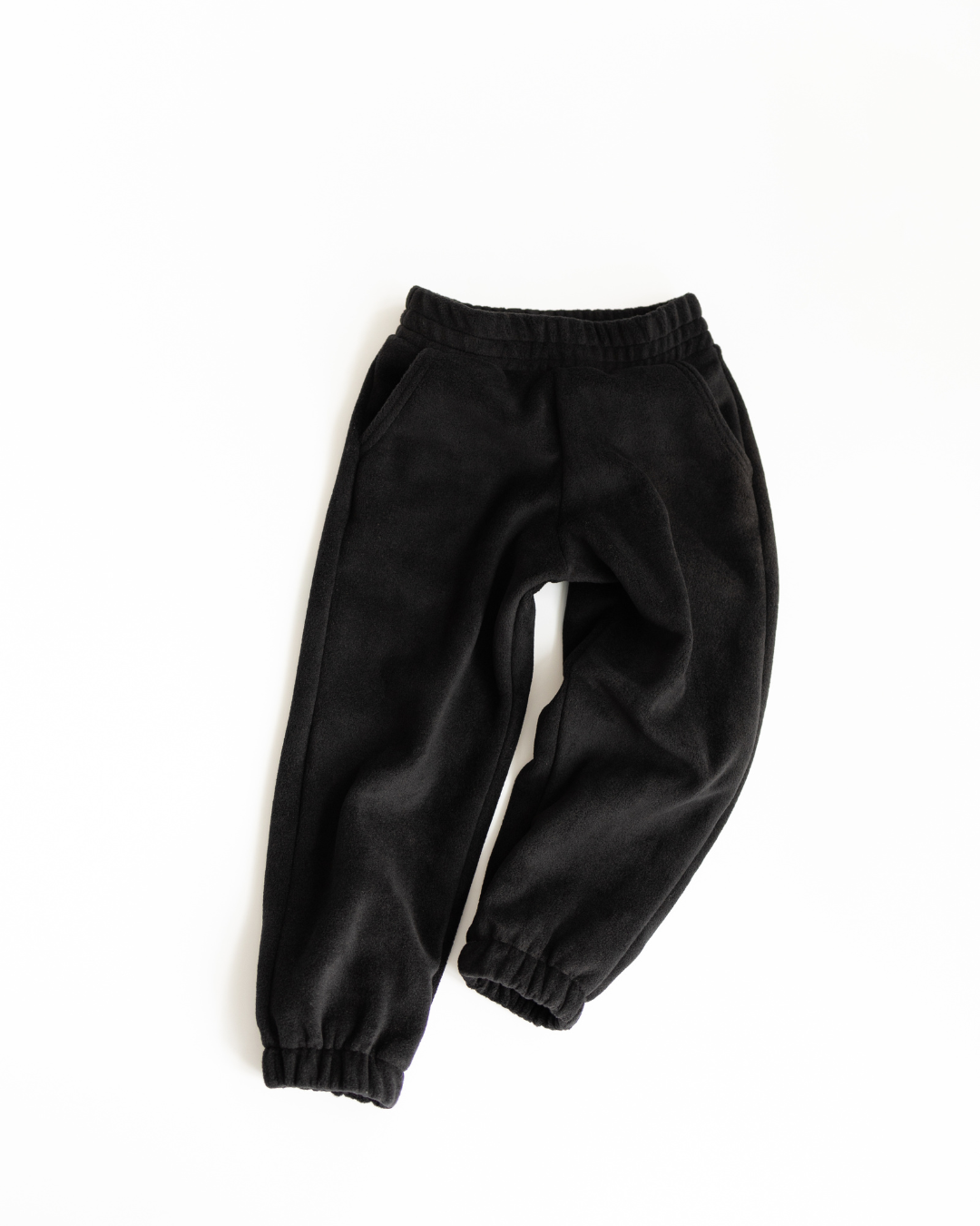 Black fleece jogger pants for children by Alwair Kids top view