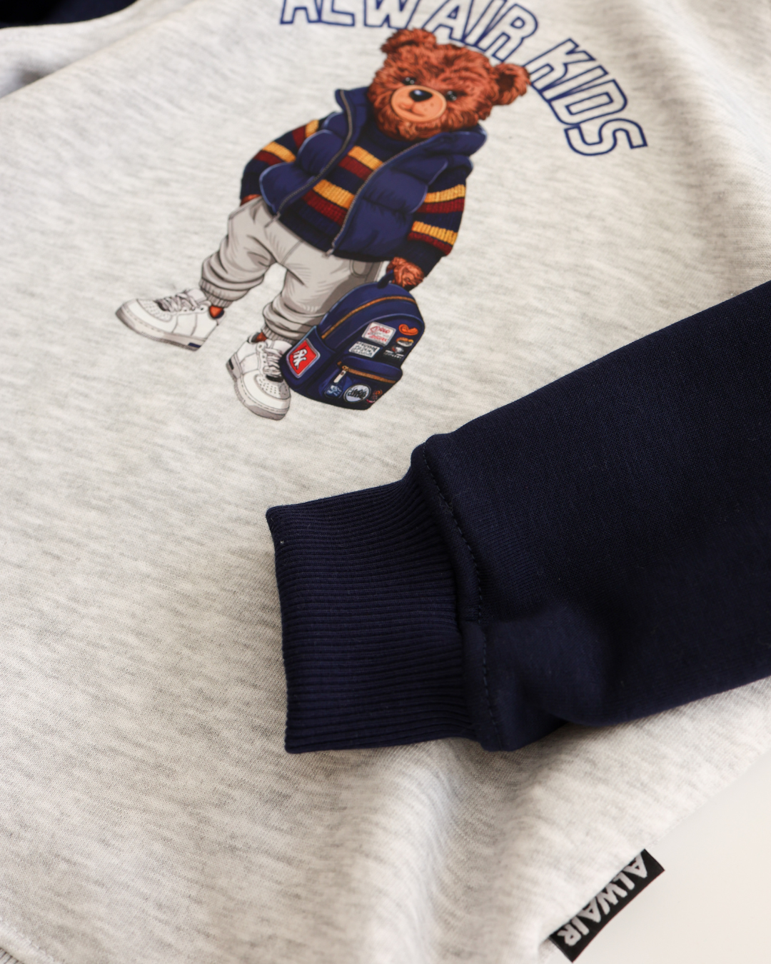 Ribbed navy cuff on boys cotton hoodie with teddy print by Alwair Kids