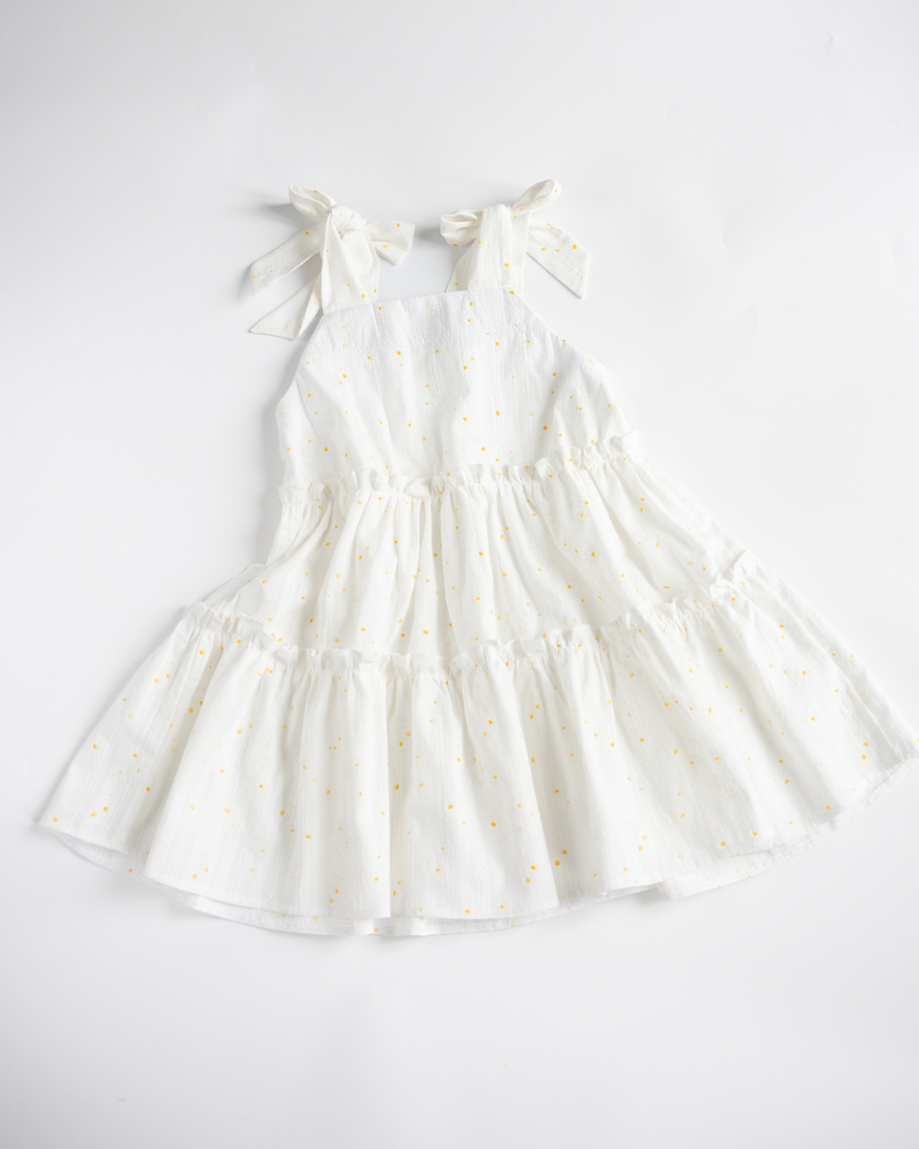 Back view of girls tiered sundress in white with tie straps