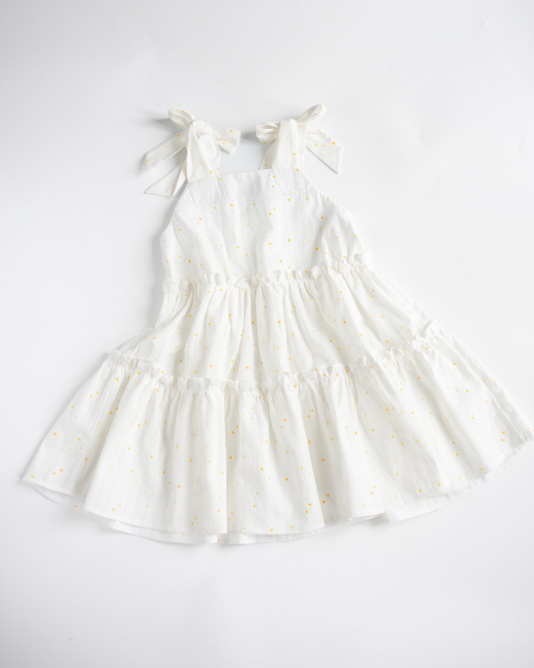 Back view of girls tiered sundress in white with tie straps