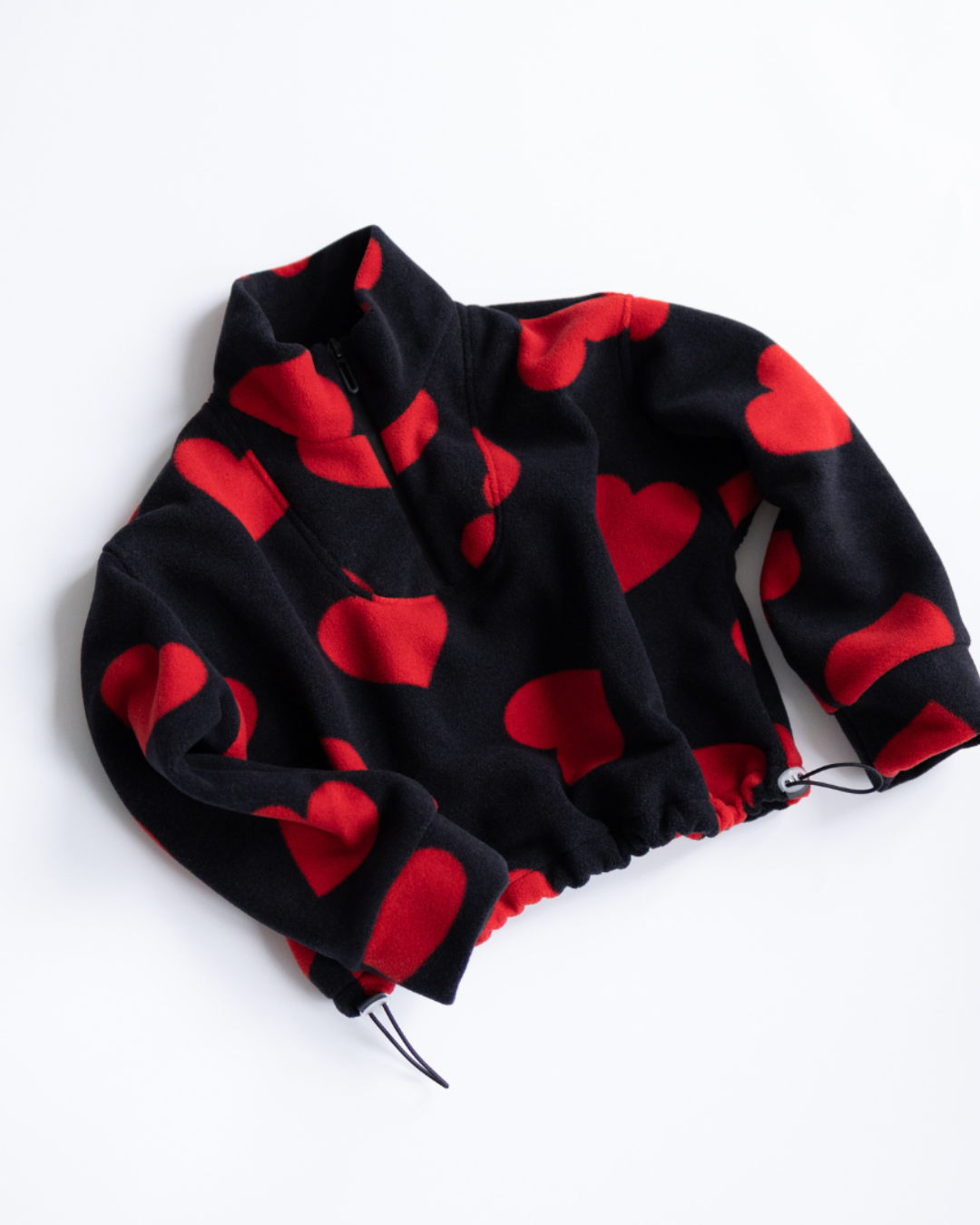 Red heart fleece pullover for girls with quarter zip and drawstring hem