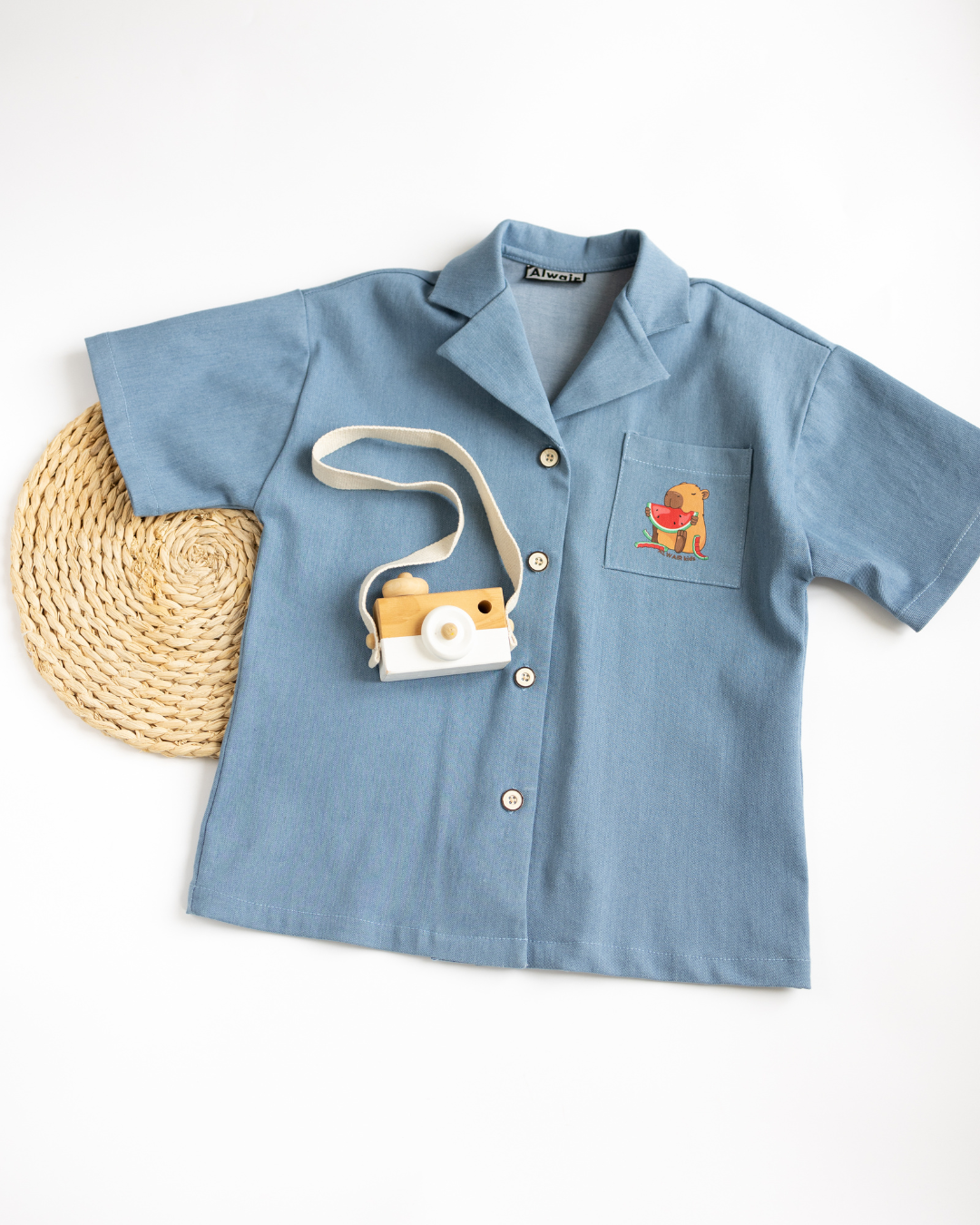 Front view of girls denim shirt with chest pocket and print