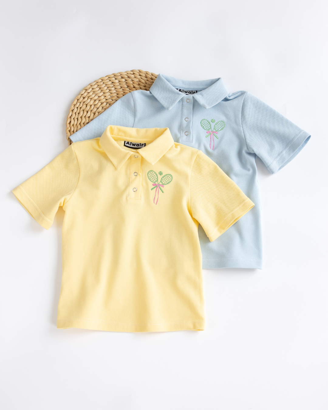 Yellow and light blue tennis polo shirts for kids by Alwair Kids laid flat