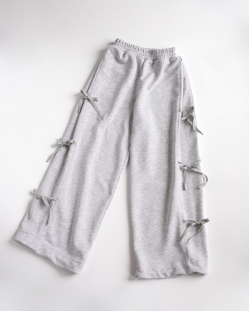 Flat lay of gray girls palazzo pants with ribbon details by Alwair Kids