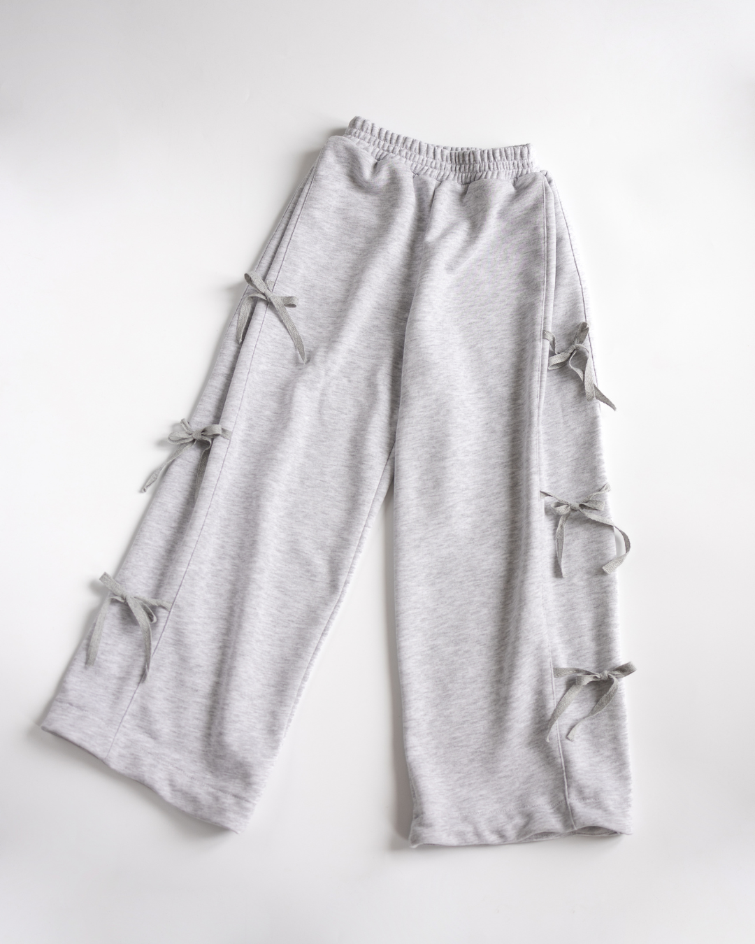 Flat lay of gray girls palazzo pants with ribbon details by Alwair Kids