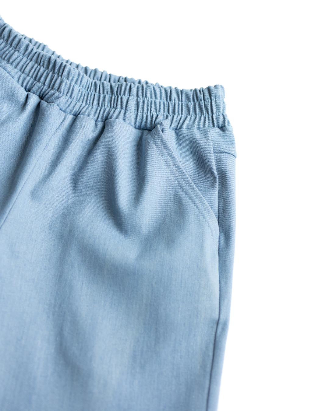 Close-up view of side pocket on light blue denim shorts for boys