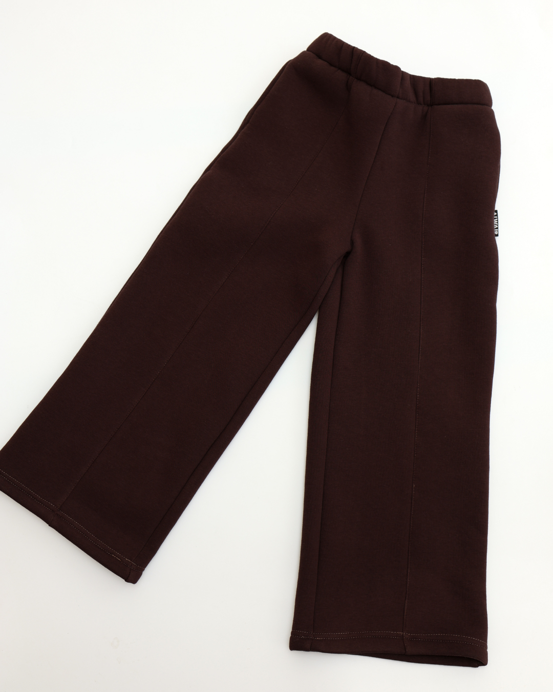 Flat lay of brown wide-leg pants for girls by Alwair Kids on white background