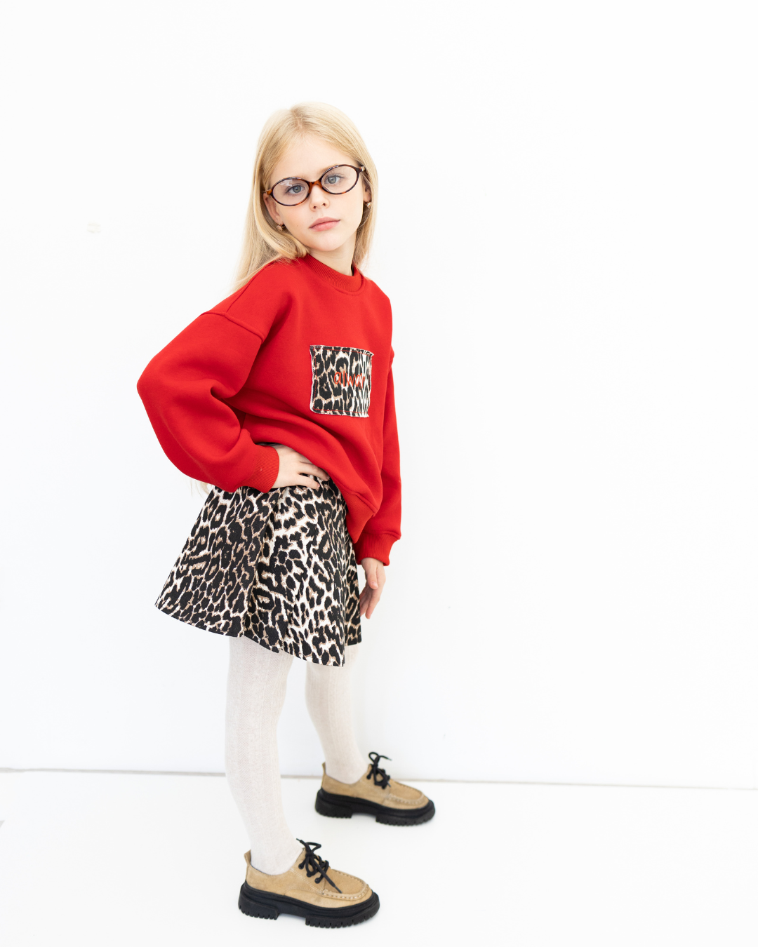 Side pose of girl in red leopard print sweatshirt from Alwair Kids Leo collection