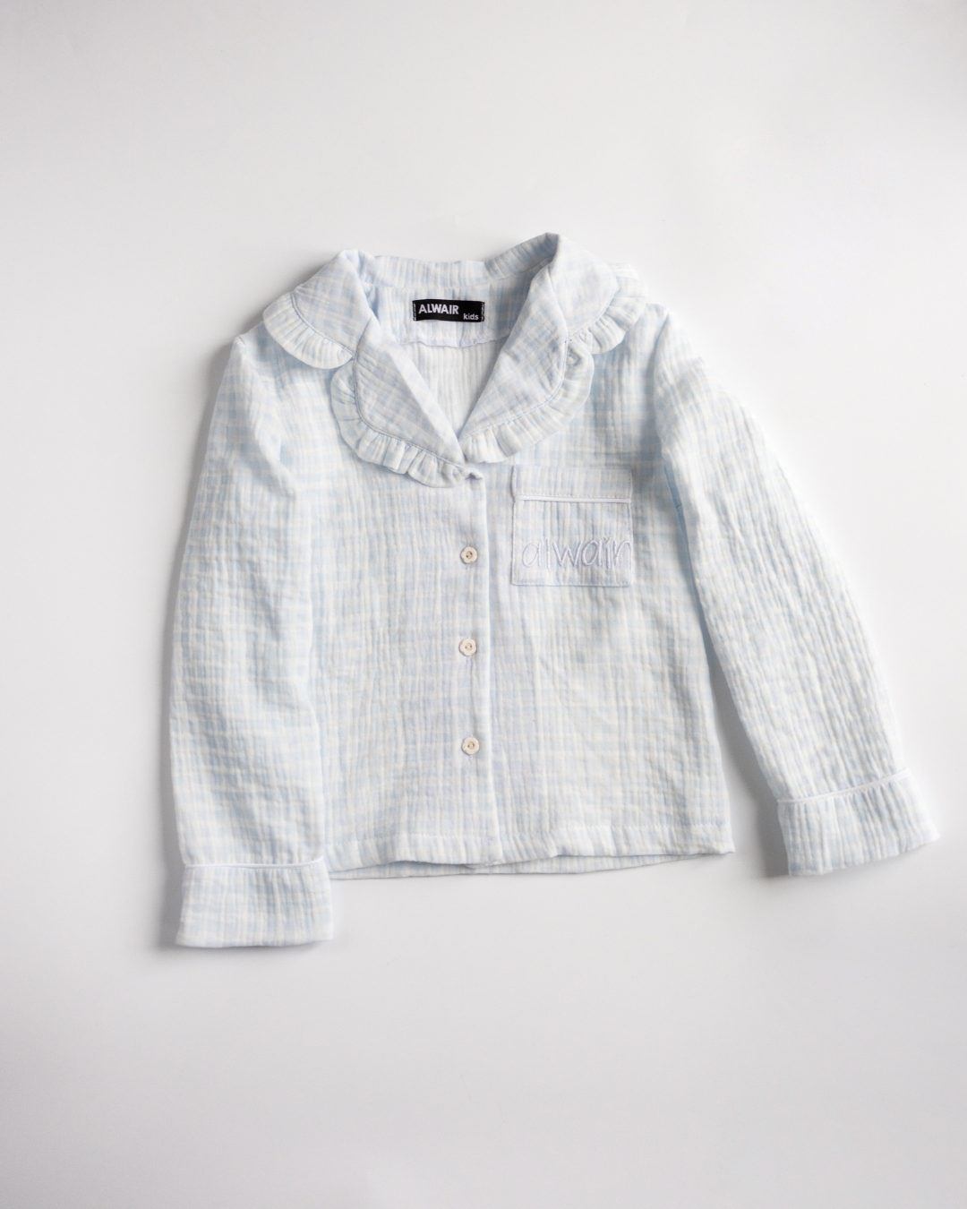 Close-up of girls’ muslin pajama shirt in blue with ruffle collar
