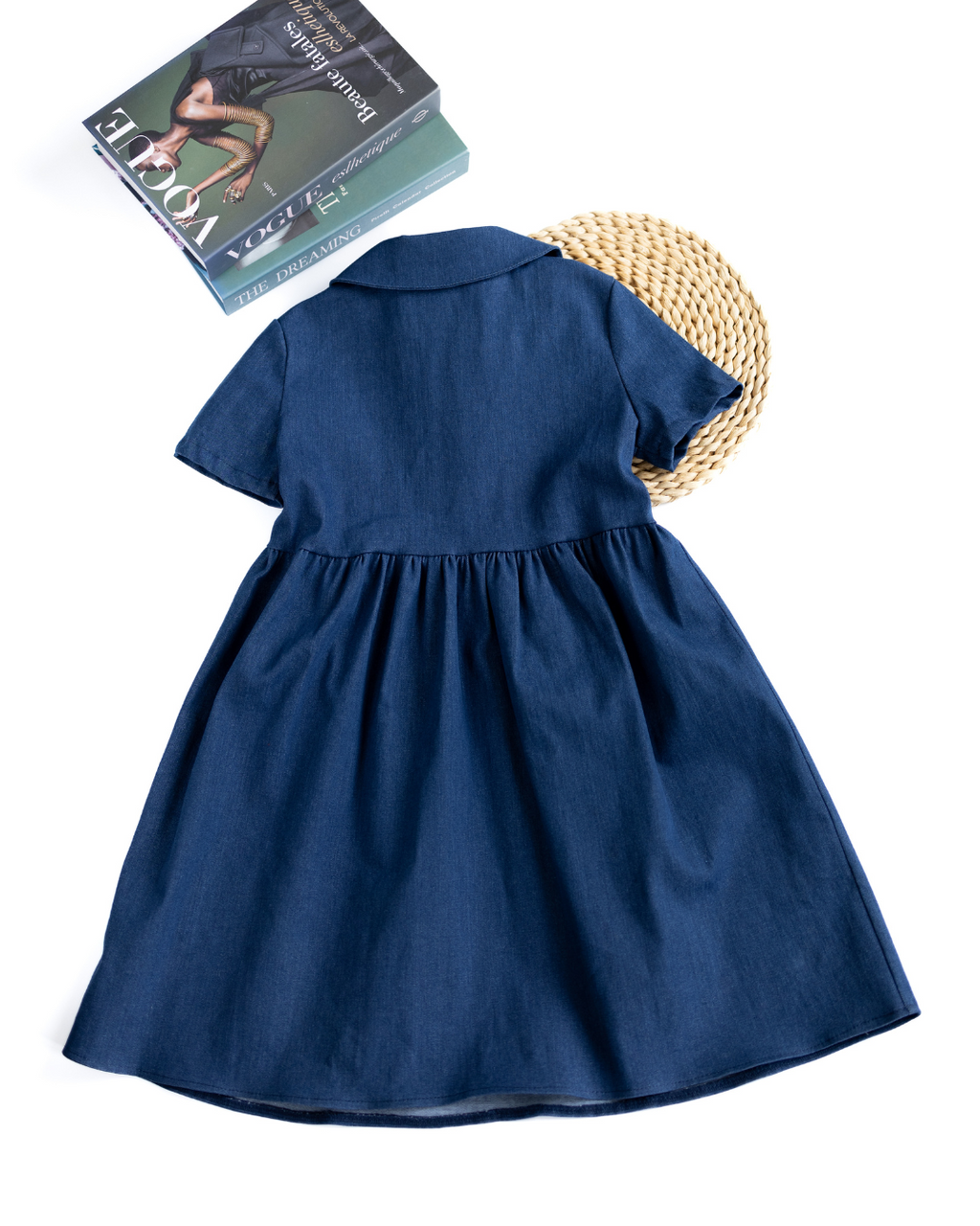 Back view of denim tennis dress for kids by Alwair Kids laid flat