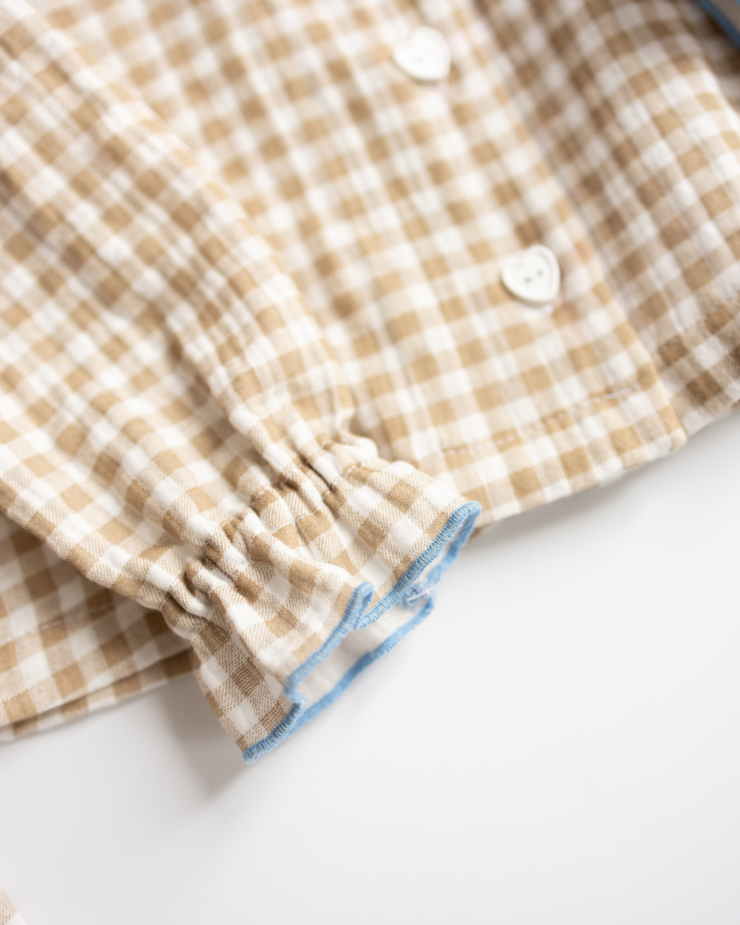 Ruffled sleeve cuff detail of beige girls' pajama shirt – soft cotton finish