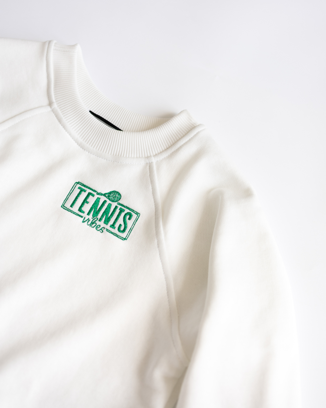 Close-up of Tennis Vibes print on white boys sweatshirt by Alwair Kids