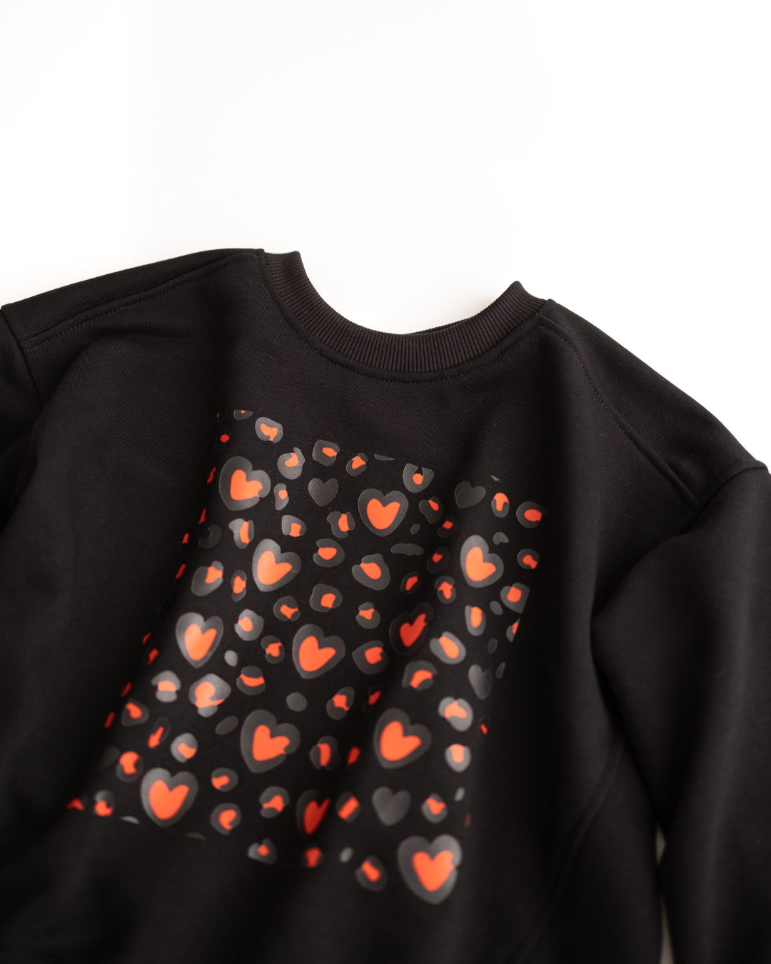 Close-up of black sweatshirt neckline and shoulder seam