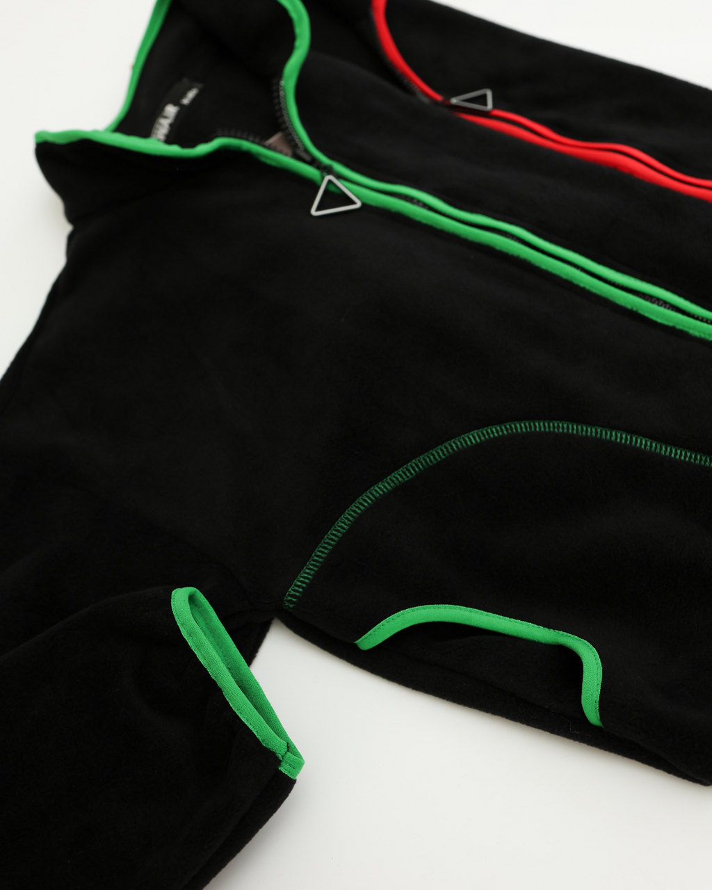 Detailed view of pocket and stitching on green-trim fleece jacket by Alwair Kids
