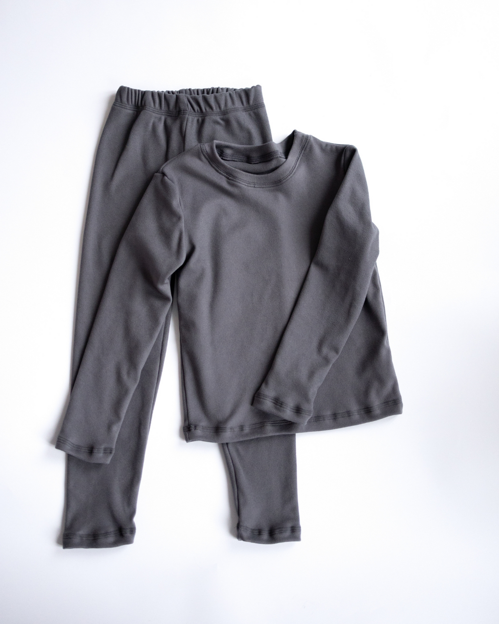 Grey thermal underwear set for kids flat lay long sleeve top and leggings