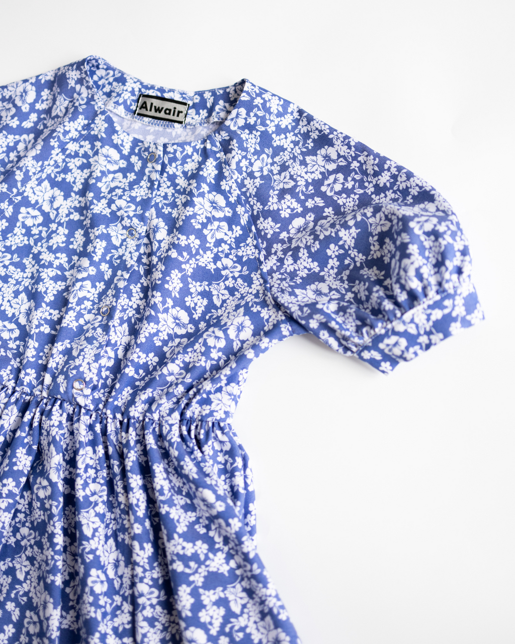 Short puff sleeve and round neckline of girls blue floral dress by Alwair Kids