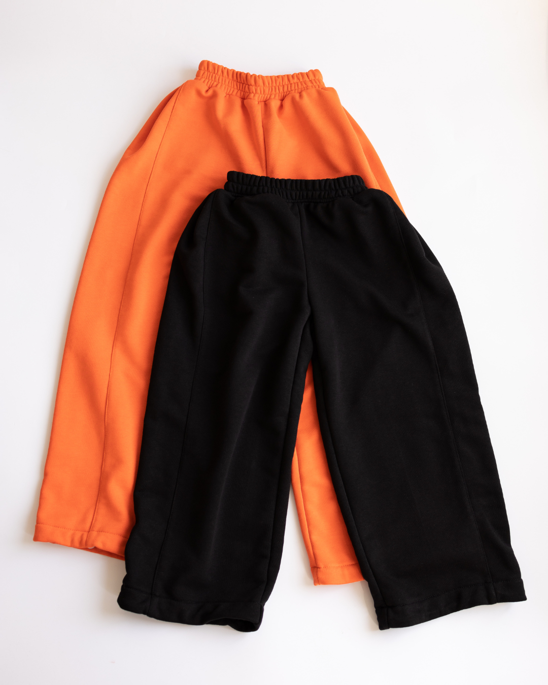 Comparison of black and orange sweatpants from Alwair Kids