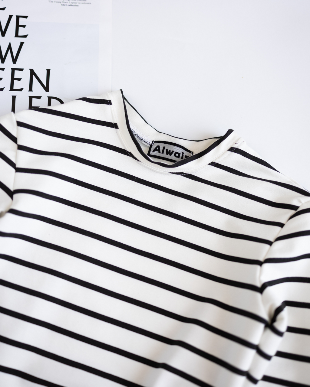Close-up of neckline and label on striped cotton long sleeve Alwair Kids