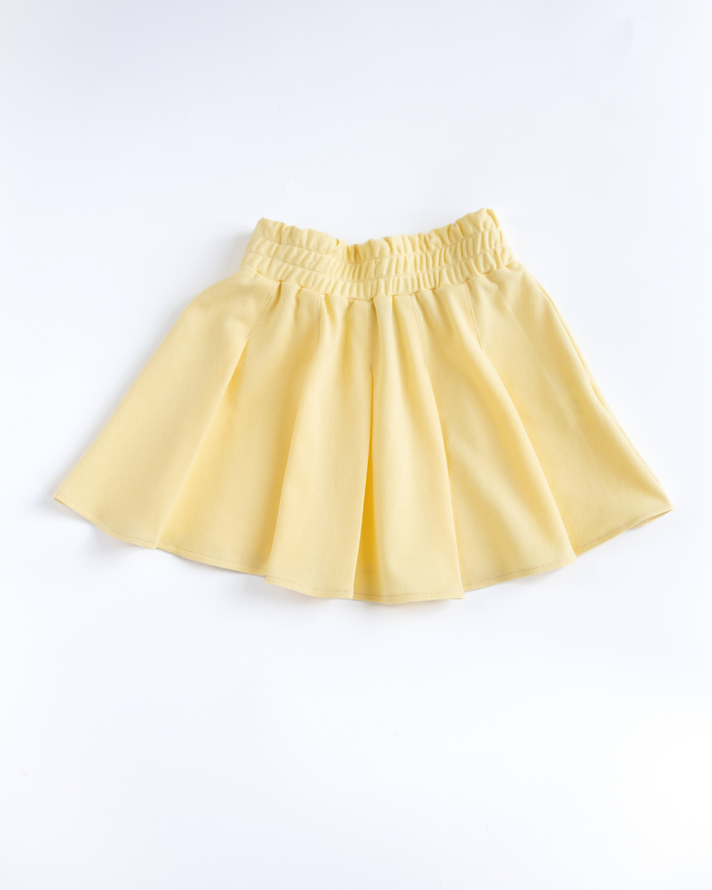 Yellow pleated lacoste skirt for girls flat lay Alwair Kids