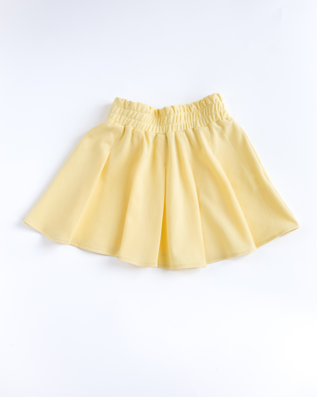 Yellow pleated lacoste skirt for girls flat lay Alwair Kids