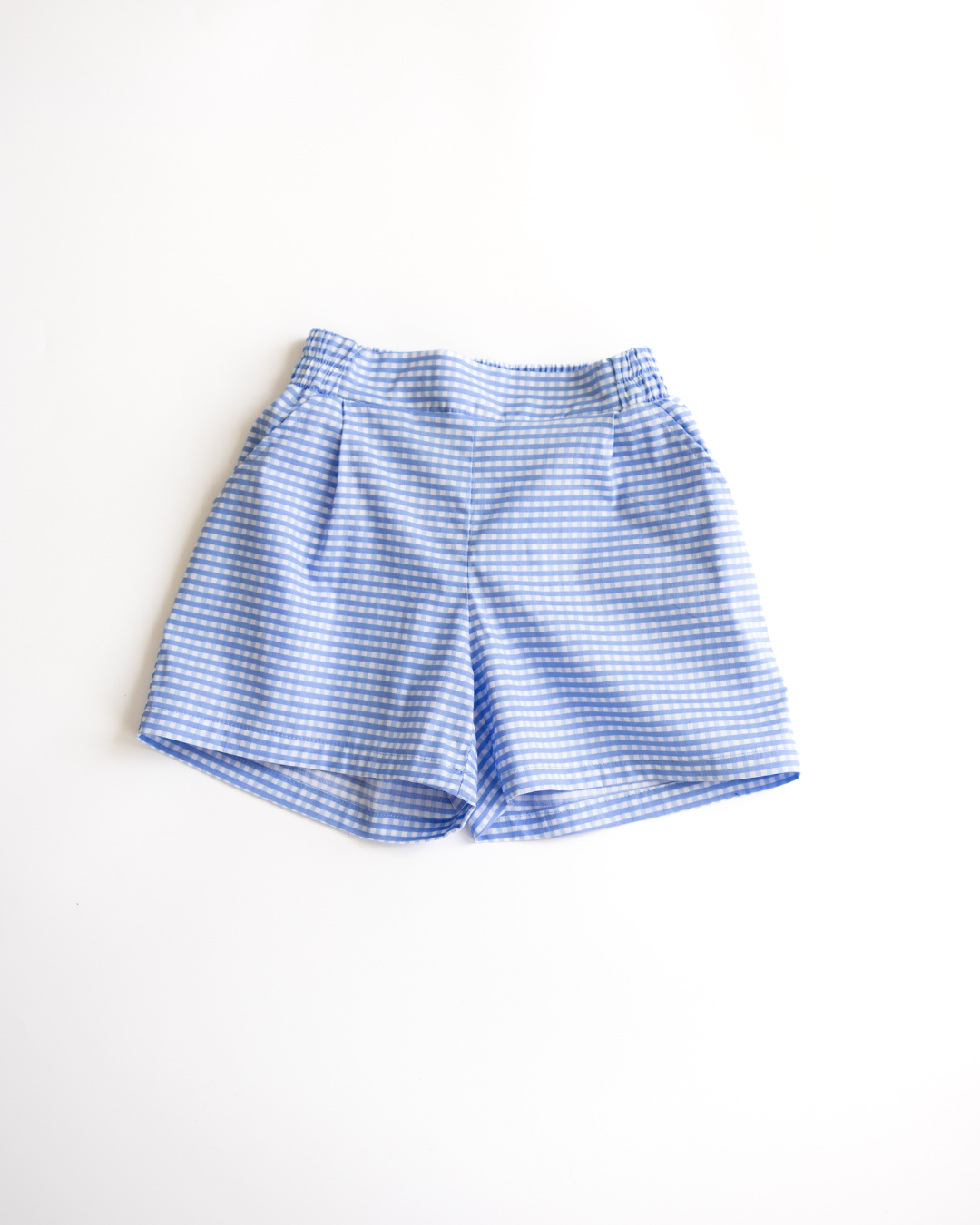 Front view of blue gingham cotton shorts for girls by Alwair Kids