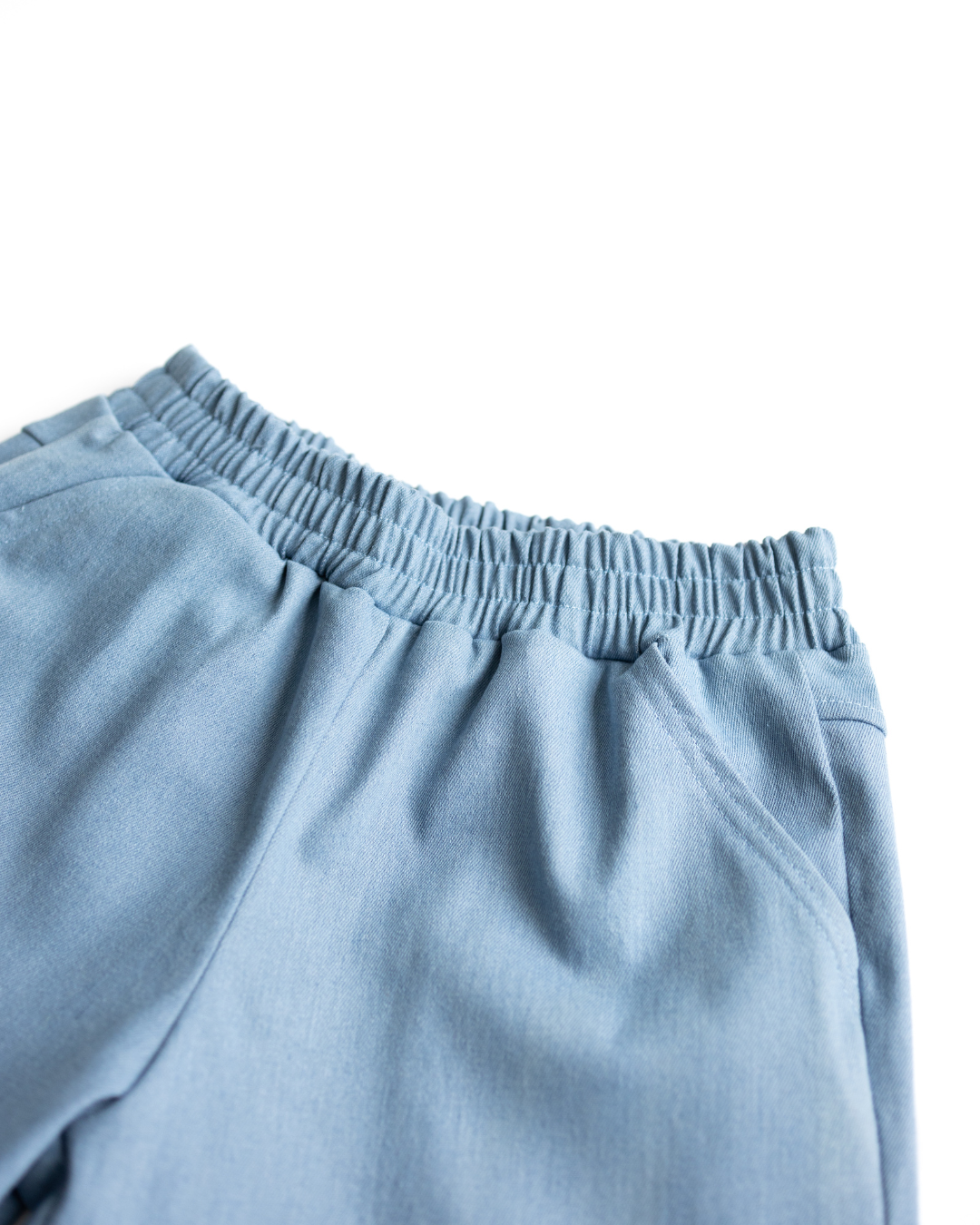 Elastic waistband detail of light blue denim shorts by Alwair Kids