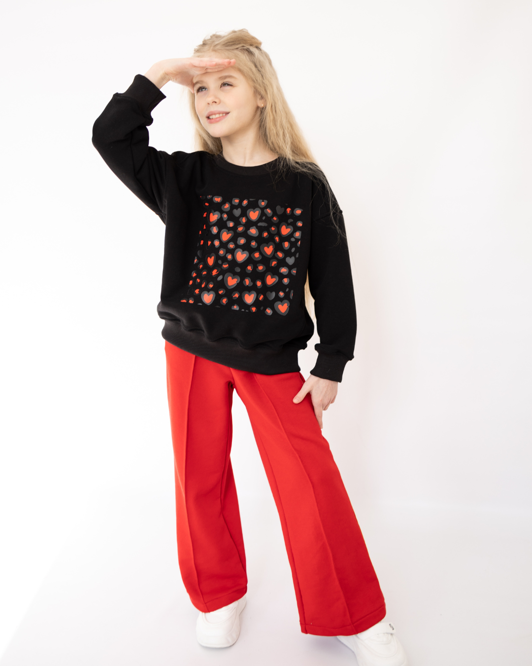 Girl wearing red DIANA pants with black sweatshirt