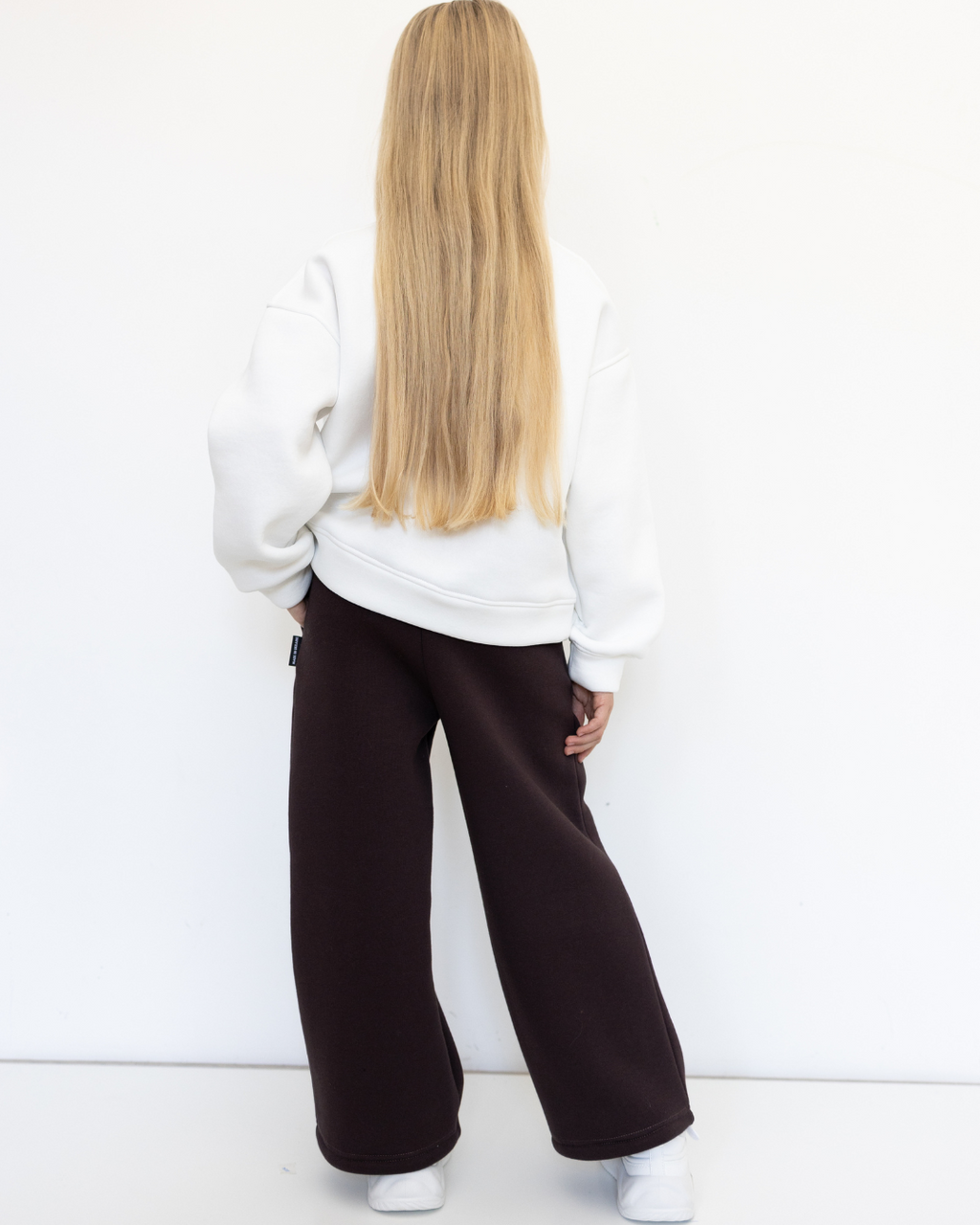 Back view of girl in brown knit palazzo pants by Alwair Kids