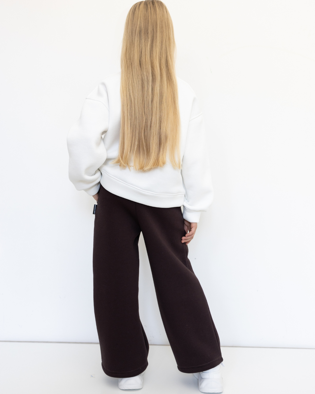 Back view of girl in brown knit palazzo pants by Alwair Kids