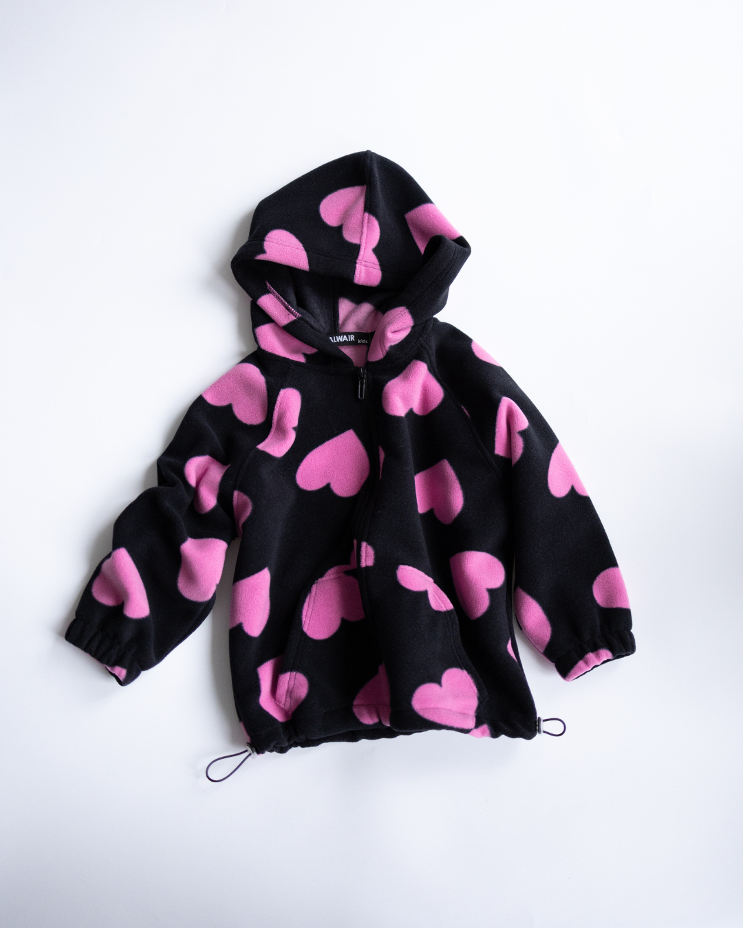 Black fleece hoodie with pink heart print flat lay Alwair Kids