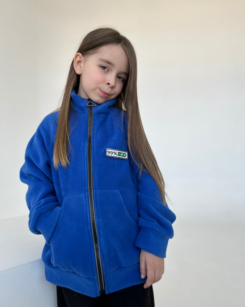 Girl in blue fleece mood jacket for kids with battery patch by Alwair Kids