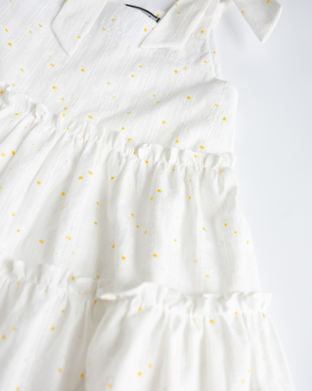Detailed view of fabric and elastic waist on girls cotton sundress