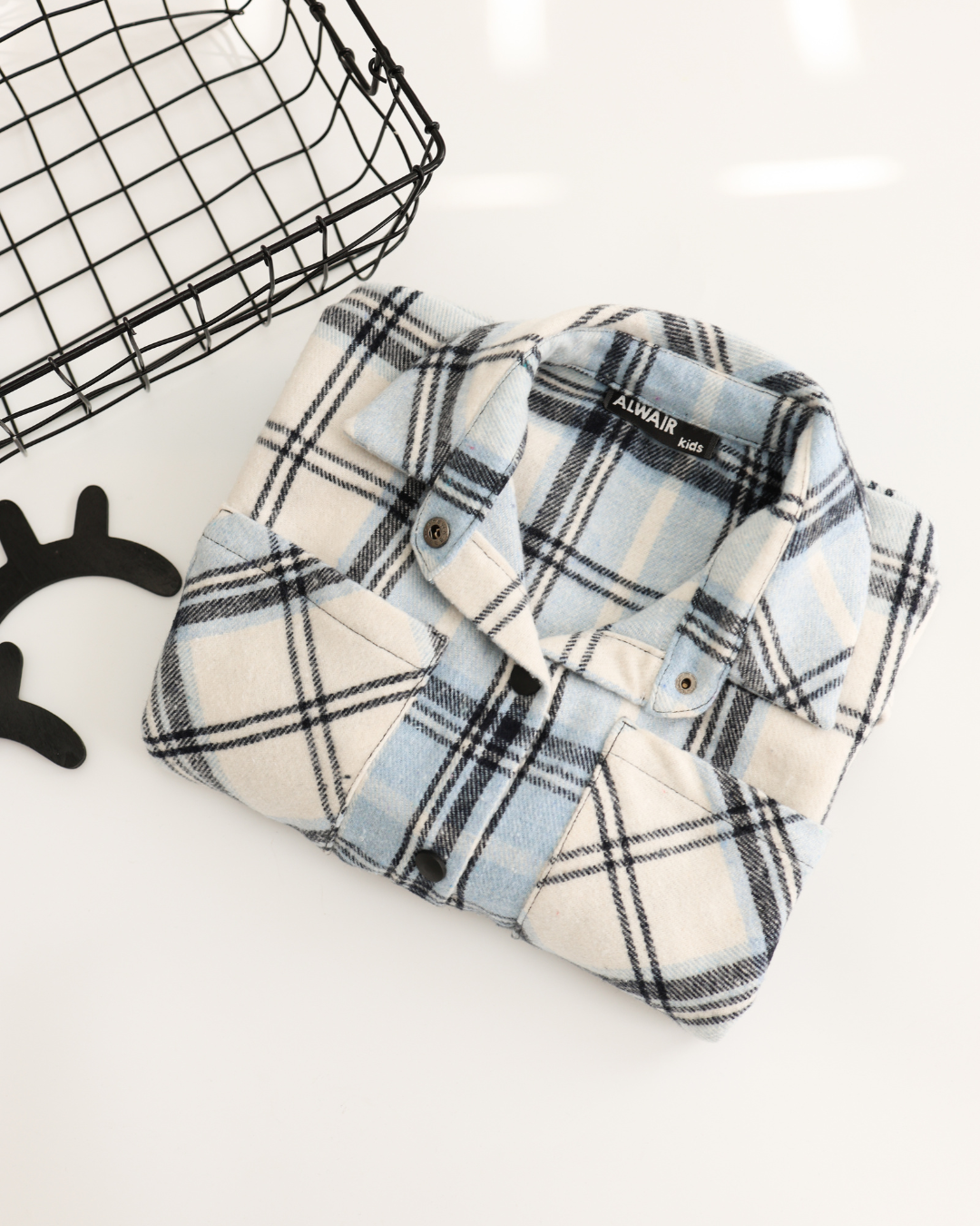 Folded cotton plaid shirt in blue and white tones for kids